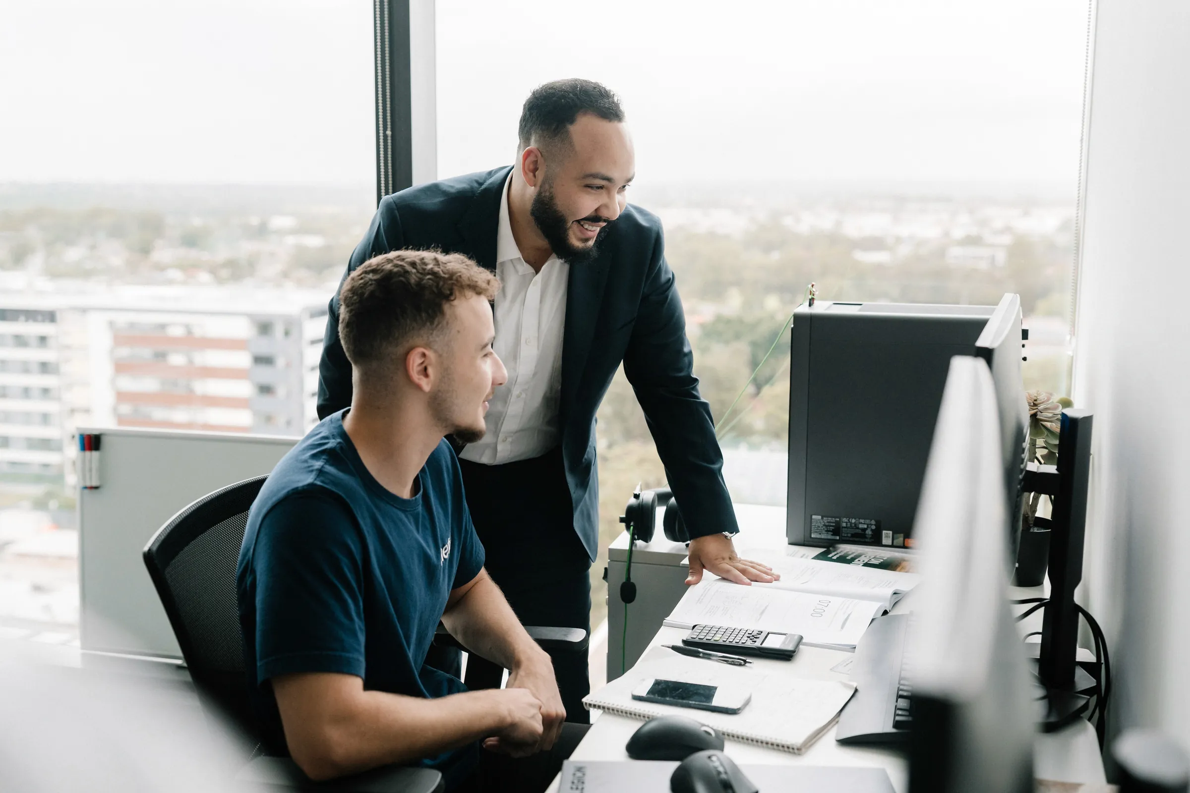 Metric Engineering engineers reviewing work at a desk